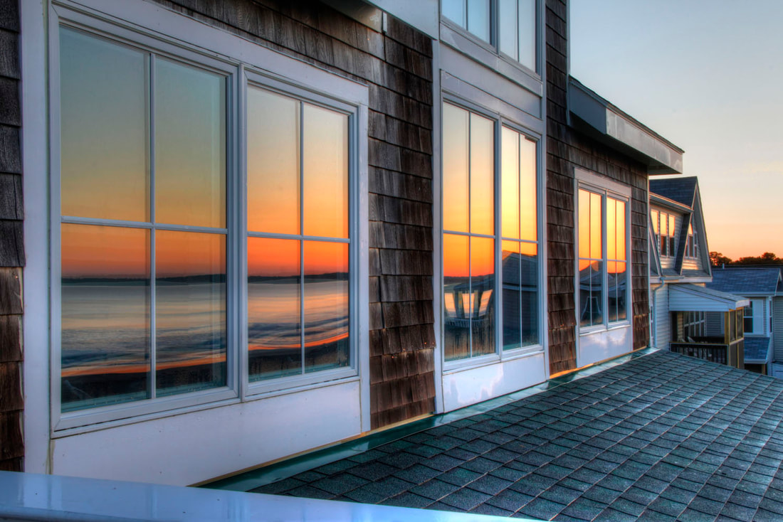 Pretty home with reflective window tinting at sunset